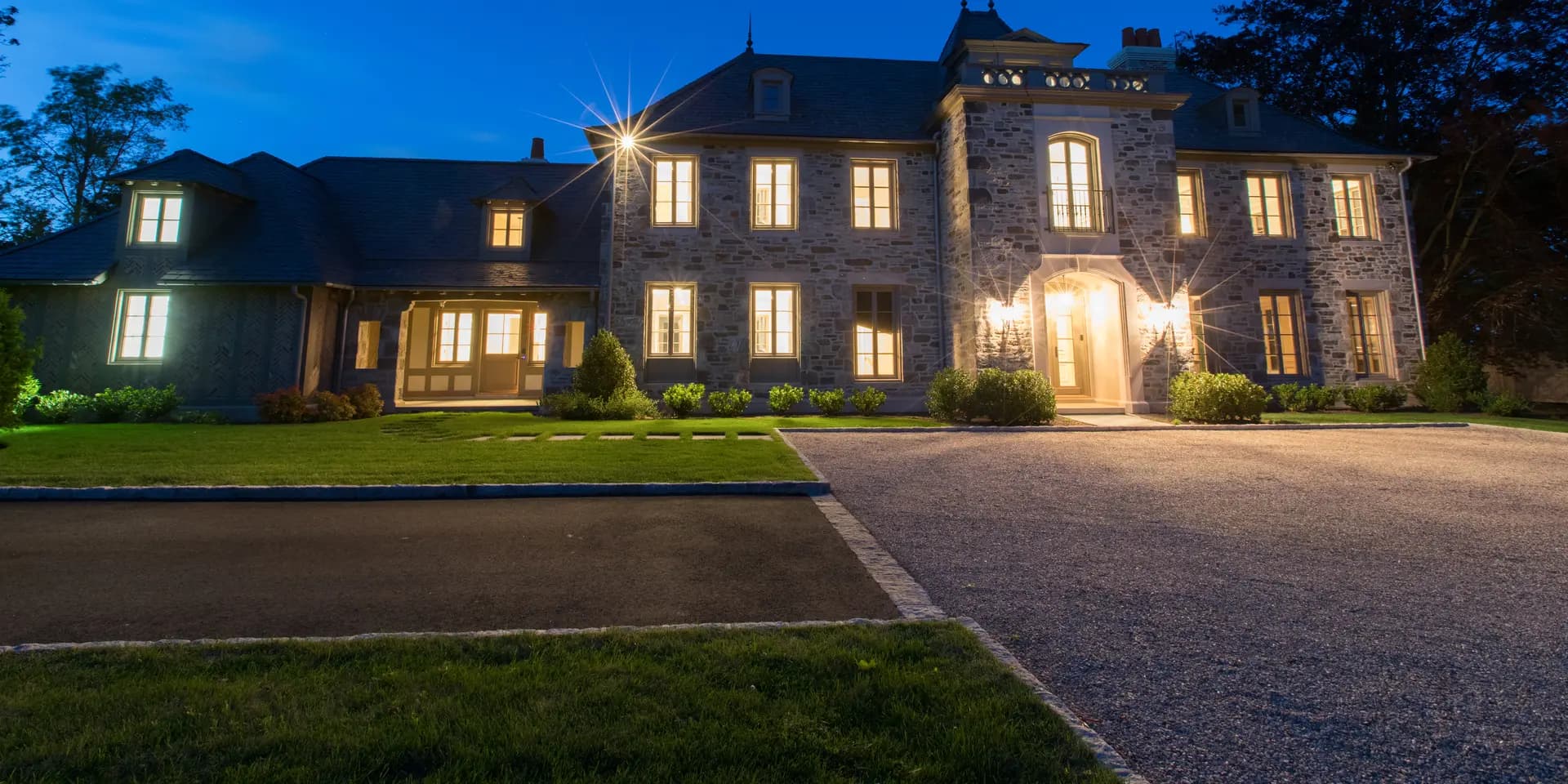 Stone manor lit at twilight